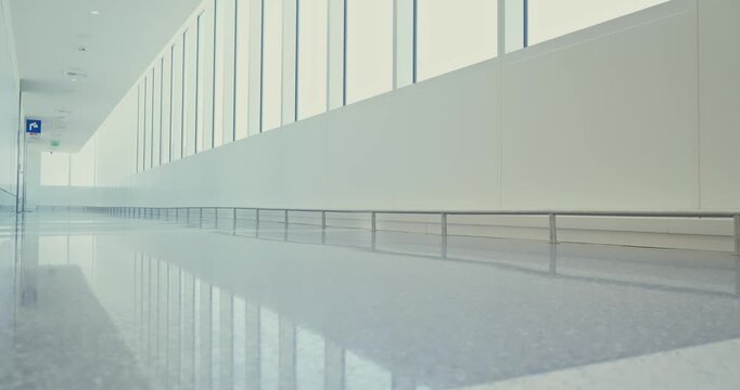 Traveler Walking with Luggage in Bright Airport Corridor