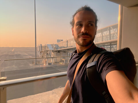 Man at Airport Gate During Sunrise