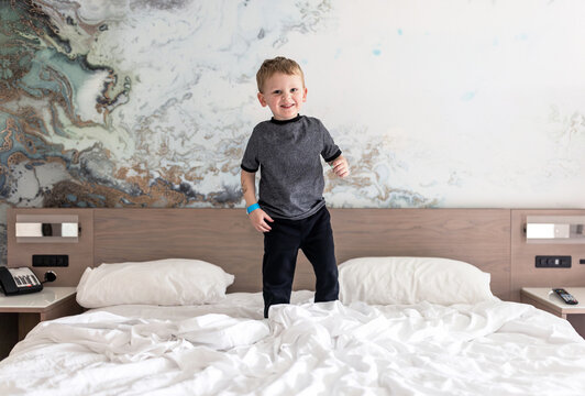 Boy jumping on Bed