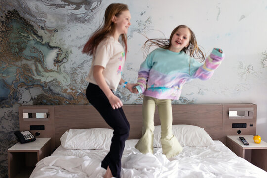 Girl jumping in hotel room