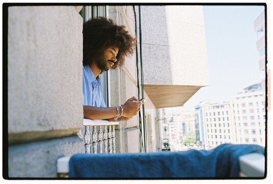 Man Using Smartphone Urban Balcony