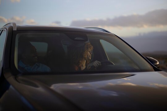 Driving Through a Scenic Landscape During Sunset on a Long Road Trip