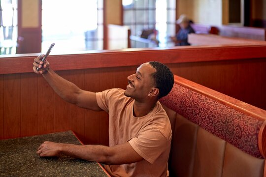 Man Taking Selfie in Restaurant During Afternoon