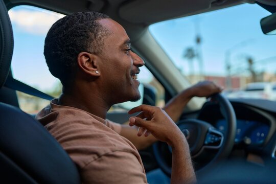 Man Enjoys Driving in his New Car on a Sunny Day
