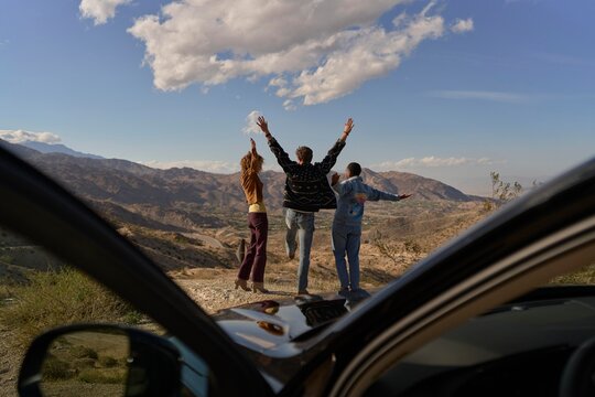 Friends Enjoy Breathtaking Mountain View During Sunset Adventure