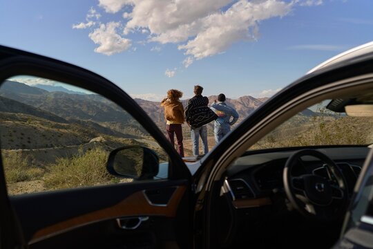 Friends Enjoying a Scenic View in the Mountains During Daytime