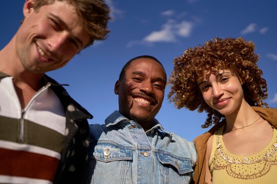 Friends Share Smiles Outdoors on a Sunny Day