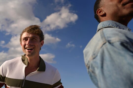 Friends Enjoying a Sunny Day Outdoors With Bright Blue Skies