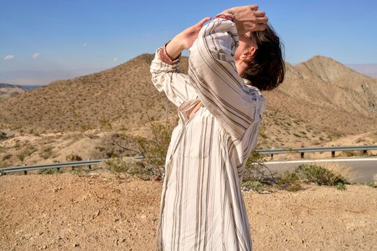 Individual stretching in scenic desert landscape under clear sky
