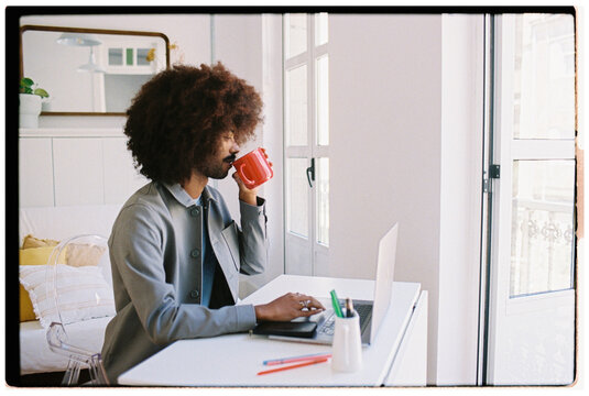 Working From Home While Enjoying Coffee in Bright Room