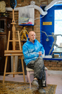 
portrait of a male sculptor in his workshop