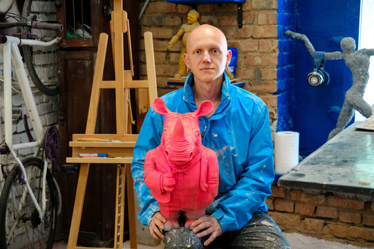 
portrait of a male sculptor in his workshop