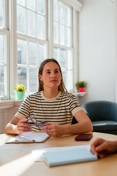 Young woman listening her workmates in a business meeting