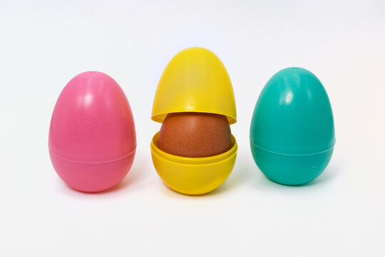 Colorful plastic easter eggs revealing a brown egg surprise