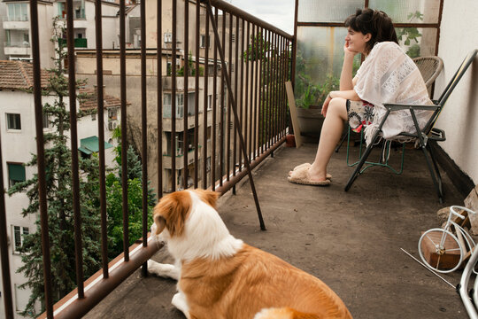 Relaxing on the Balcony with a Beloved Dog