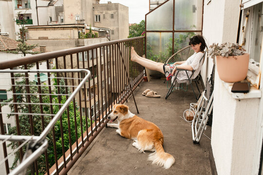 Relaxing on the Balcony with a Beloved Dog