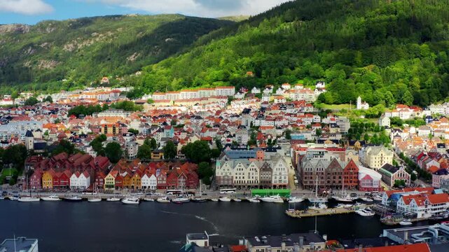 Aerial drone footage of the medieval Bergenhus Fortress in Bergen. Close-up view of Haakon Hall and Rosenkrantz Tower next to the harbor on a clear summer day in scenic Norway