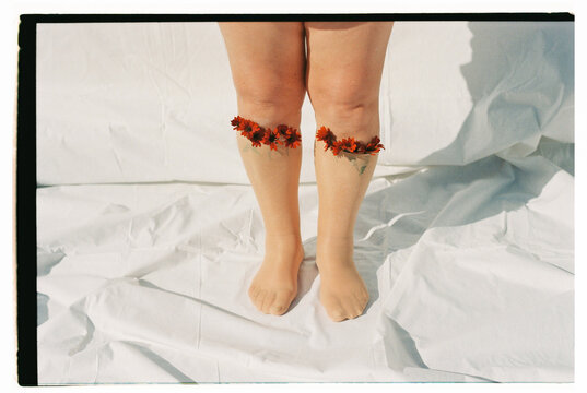 woman's legs with socks and flowers