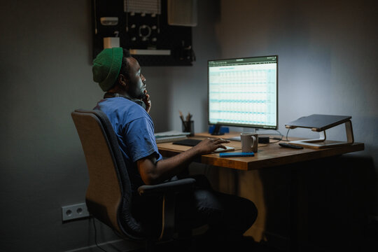 A man uses a computer at night