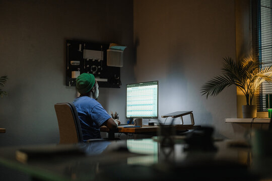 A man uses a computer at night