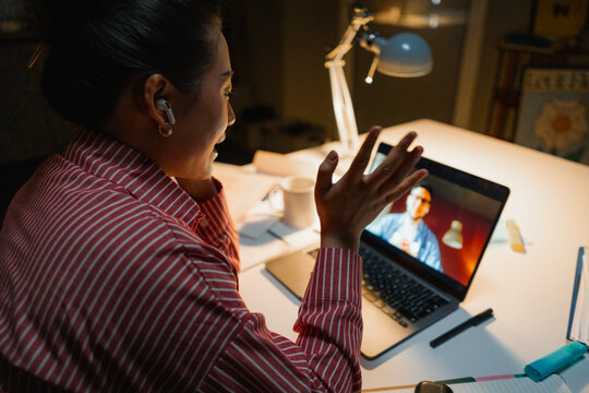 A woman is talking on a video chat at night