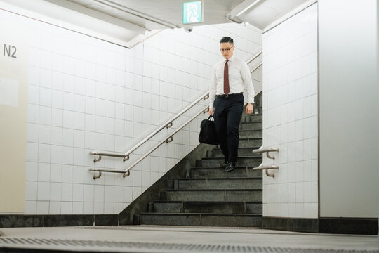 The man goes down into the underpass