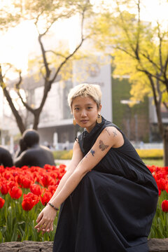 Woman Sitting Among Tulips