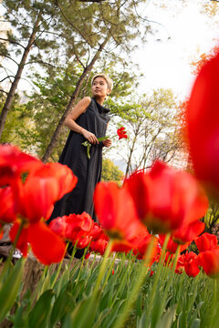 Woman Standing in Tulip Field