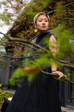 Woman Beside Tree Branches