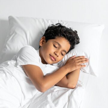 Peaceful Young Boy Sleeping Soundly in White Bed.