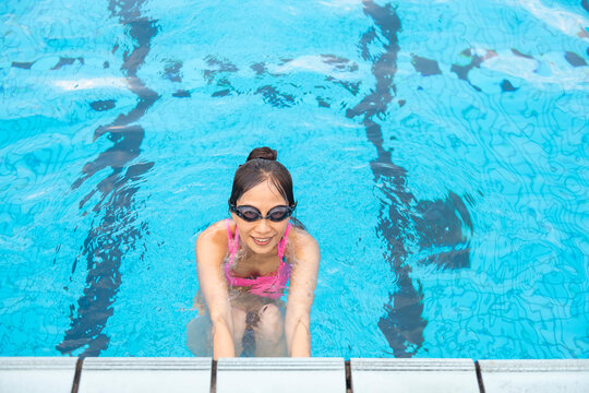 Woman Swimming Pool Pink Bikini Goggles Clear Blue Water