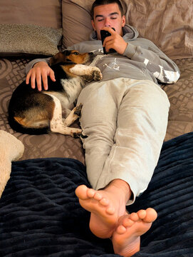 Young man on his phone with beagle buddy