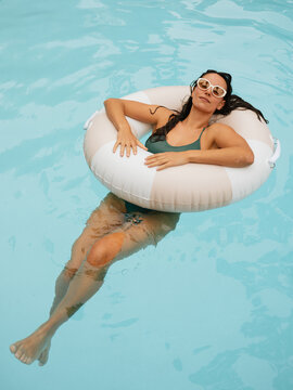 Relaxing in the Pool on a Warm Sunny Day With a Float
