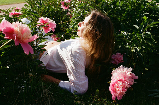 Pregant woman relaxing on blooming garden