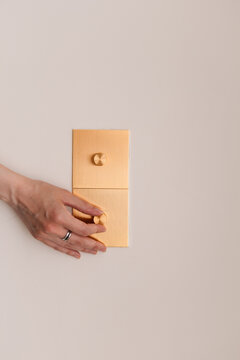 Golden Dimmer Switch Close-Up with Female Hand