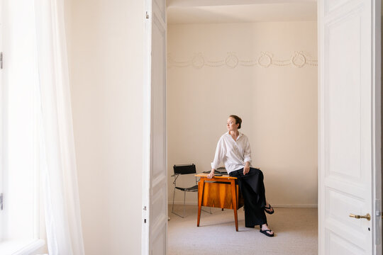 Thoughtful Remote Worker in Vintage Mid-Century Interior