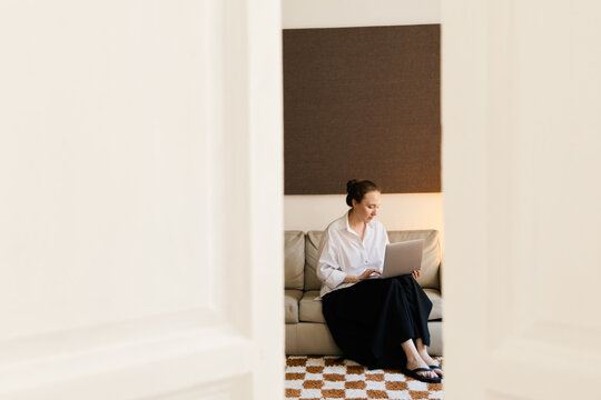 Woman Working on Laptop in Cozy Minimalist Interior
