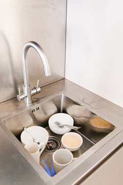  Piled Dirty Dishes in Stainless Steel Sink