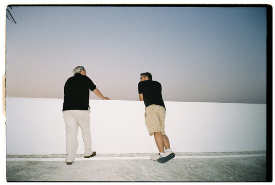 Men on Rooftop at Dusk