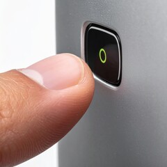 Close Up Of A Thumb Pressing A Green Illuminated Button On A Silver Electronic Device With A White Background
