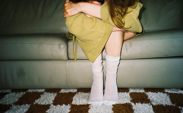 Overwhelmed Woman Sitting on Couch
