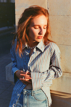 Model Poses Against a Stone Wall in Soft Evening Light