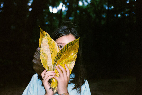 Girl Hiding Behind Leaves in Forest. Film