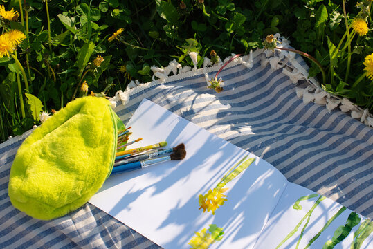 Bright tassels lie on a striped blanket