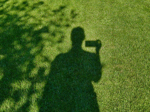 selfie shadow of a person on the grass