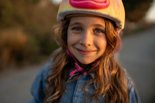 Joyful Girl at Sunset in Unicorn Helmet