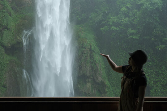 Woman Reaching Waterfall