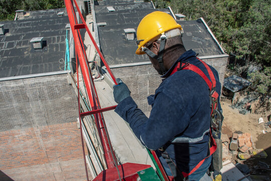 Worker performing safety checks on construction platform