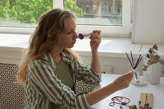 Woman applying makeup 