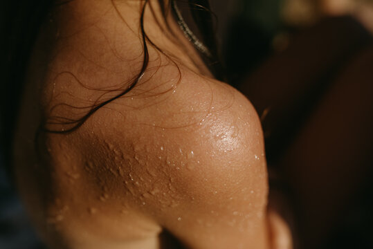 Close up of a Girl's Shoulder With Water Droplets And Wet Hair